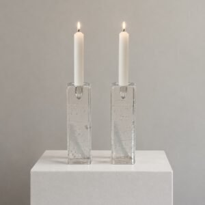 Pair of Iittala Arkipelago glass candle holders by Timo Sarpaneva displayed with lit taper candles